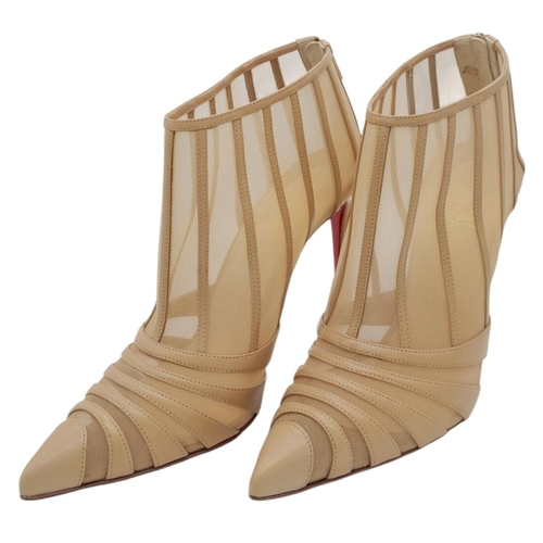 511 - A pair of Christian Louboutin Baleine Heels. Beige mesh with leather stripes, pointed toe, and zip c... 