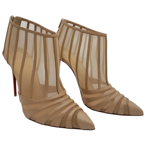 511 - A pair of Christian Louboutin Baleine Heels. Beige mesh with leather stripes, pointed toe, and zip c... 