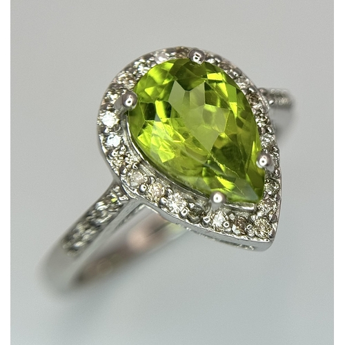 547 - A Peridot Gemstone Ring with Diamond Surround. Set in 925 Silver. Size N. 3.3g. CD-1680