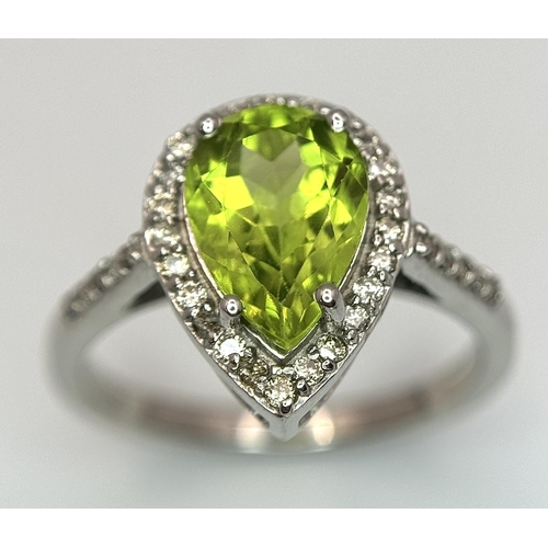 547 - A Peridot Gemstone Ring with Diamond Surround. Set in 925 Silver. Size N. 3.3g. CD-1680