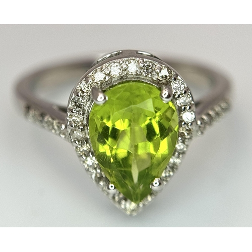 547 - A Peridot Gemstone Ring with Diamond Surround. Set in 925 Silver. Size N. 3.3g. CD-1680