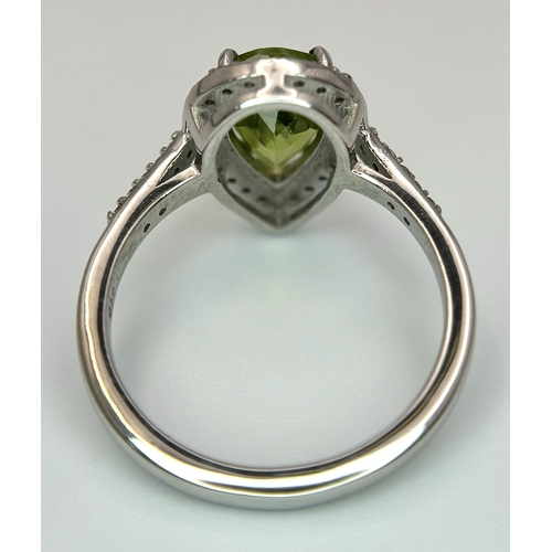 547 - A Peridot Gemstone Ring with Diamond Surround. Set in 925 Silver. Size N. 3.3g. CD-1680