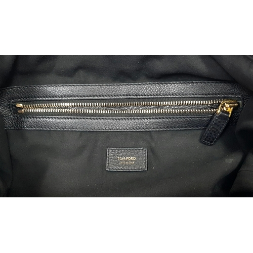 573 - A Tom Ford Black Amber Tote Bag. Pebbled leather exterior with gold-toned hardware, zipper details, ... 