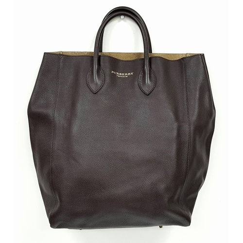 601 - A Burberry Carryall Tote Bag. Dark burgundy leather exterior with gold-toned hardware, four protecti... 