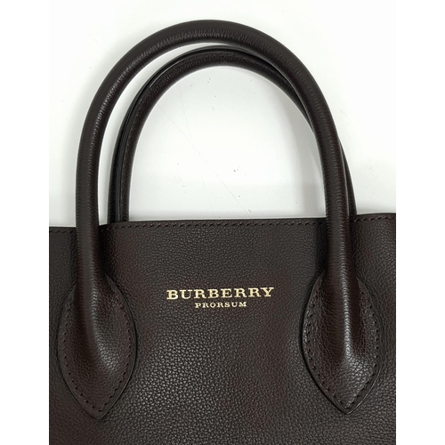 601 - A Burberry Carryall Tote Bag. Dark burgundy leather exterior with gold-toned hardware, four protecti... 