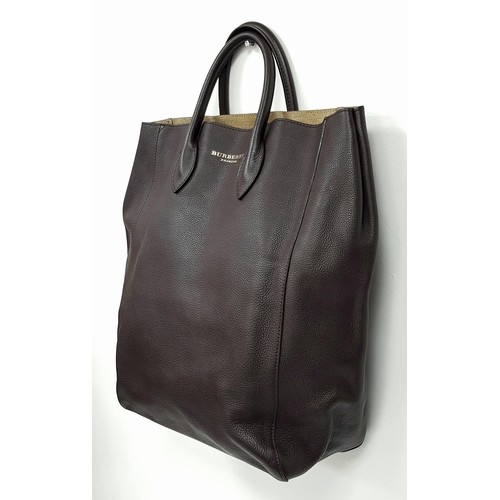 601 - A Burberry Carryall Tote Bag. Dark burgundy leather exterior with gold-toned hardware, four protecti... 