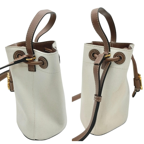 608 - A Burberry Ivory TB Mini Bucket Bag. Canvas exterior with gold-toned hardware, leather trim, adjusta... 