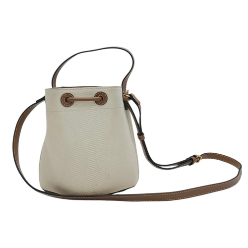 608 - A Burberry Ivory TB Mini Bucket Bag. Canvas exterior with gold-toned hardware, leather trim, adjusta... 