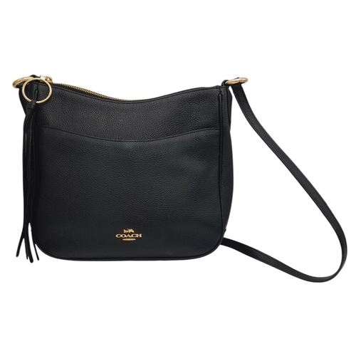 622 - A Coach Black Chaise Crossbody Bag. Pebbled leather exterior with gold-toned hardware, adjustable st... 