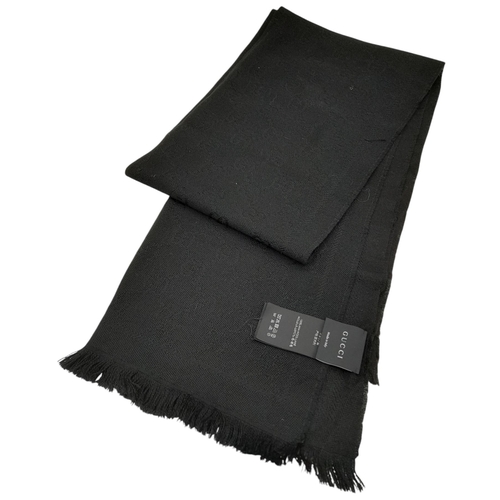 671 - A Gucci Wool Silk GG Monogram Fringe Scarf in Black, featuring the iconic GG monogram pattern throug... 