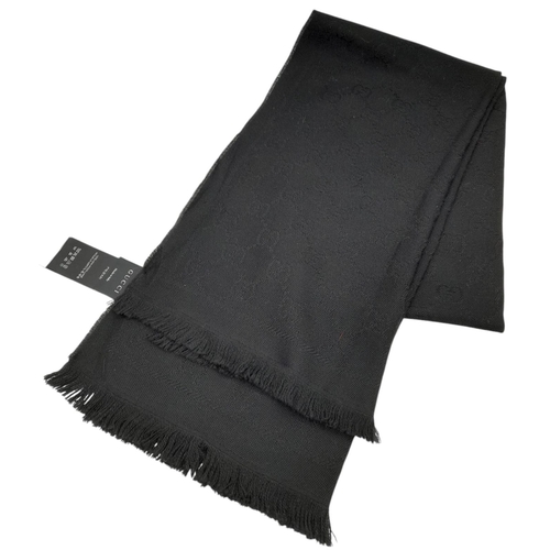 671 - A Gucci Wool Silk GG Monogram Fringe Scarf in Black, featuring the iconic GG monogram pattern throug... 