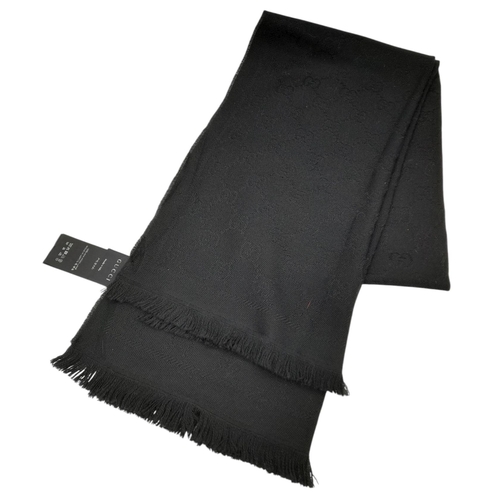 671 - A Gucci Wool Silk GG Monogram Fringe Scarf in Black, featuring the iconic GG monogram pattern throug... 