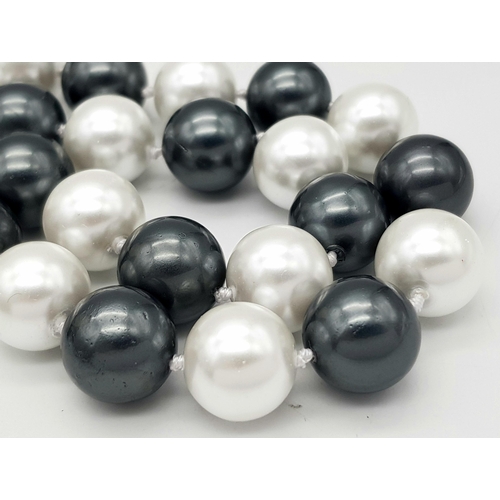 778 - A South Sea Pearl Shell Large Bead Black and White Necklace. 14mm beads. 42cm length.