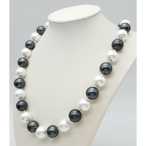 778 - A South Sea Pearl Shell Large Bead Black and White Necklace. 14mm beads. 42cm length.