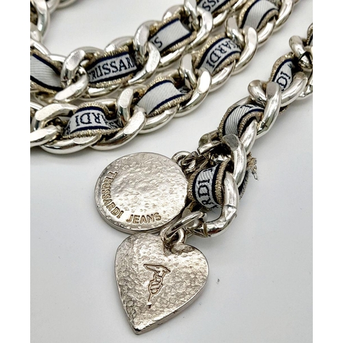 1384 - A Trussardi Silver-Toned Double Chain Belt. Silver-toned metal interwoven with fabric embroidered wi... 