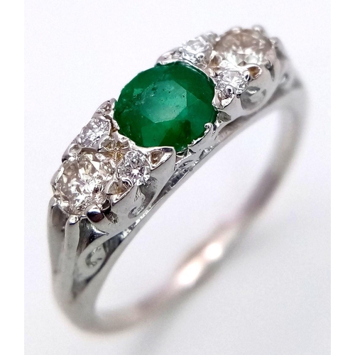 1328 - An 18K White Gold Emerald and Diamond Ring. 0.50ct Emerald with diamond accents. Size M. 3.4g total ... 