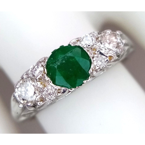 1328 - An 18K White Gold Emerald and Diamond Ring. 0.50ct Emerald with diamond accents. Size M. 3.4g total ... 