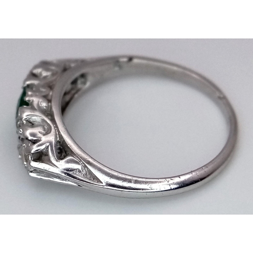 1328 - An 18K White Gold Emerald and Diamond Ring. 0.50ct Emerald with diamond accents. Size M. 3.4g total ... 