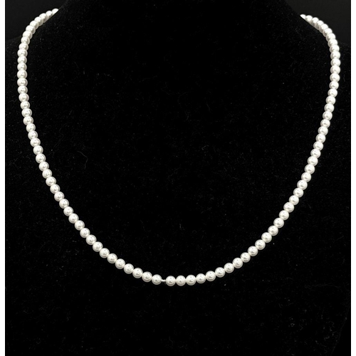 1666 - A Cultured Pearl Bead Necklace with an 18K White Gold Clasp. Pearls 3/4mm. 40cm length. 8.2g total w... 