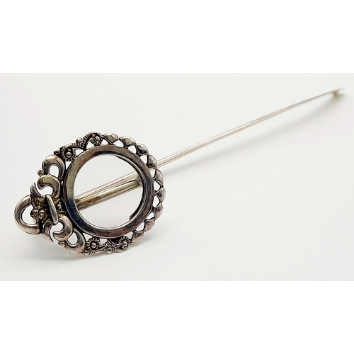 1087 - An Antique Sterling Silver Decorative Hair Pin. Shoe horn form with ornate decoration. 15cm. 13g