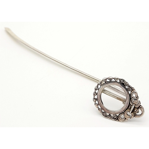 1087 - An Antique Sterling Silver Decorative Hair Pin. Shoe horn form with ornate decoration. 15cm. 13g