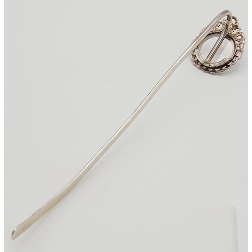 1087 - An Antique Sterling Silver Decorative Hair Pin. Shoe horn form with ornate decoration. 15cm. 13g