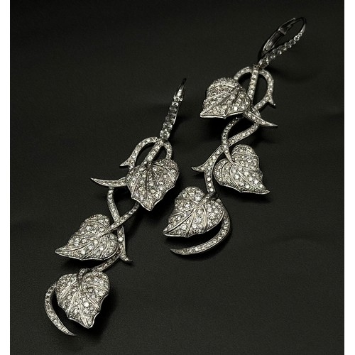 750 - A Beautiful Pair of Art Deco Style 14K White Gold and Diamond Drop Earrings. Floral form. One stone ... 