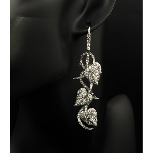 750 - A Beautiful Pair of Art Deco Style 14K White Gold and Diamond Drop Earrings. Floral form. One stone ... 