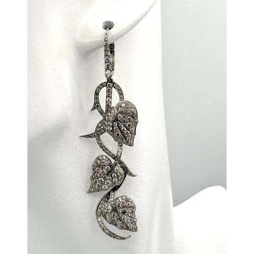 750 - A Beautiful Pair of Art Deco Style 14K White Gold and Diamond Drop Earrings. Floral form. One stone ... 