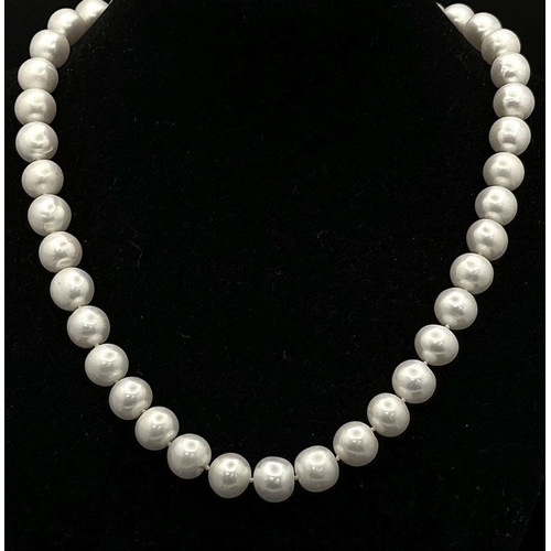 1327 - A Cultured Pearl Necklace with an 9K Gold Clasp. 12mm. 40cm. 60g