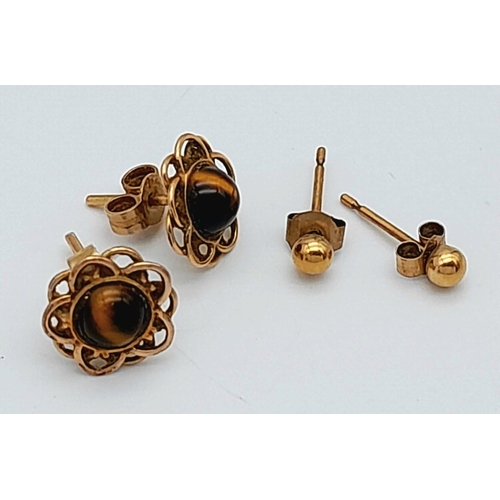 1388 - Two Pairs of 9K Yellow Gold Stud Earrings. Ball and Tigers Eye. 1.4g total weight.