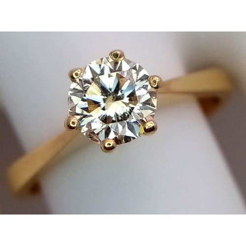 471 - An 18K Yellow Gold Diamond Solitaire Ring. A 0.75ct brilliant round cut diamond - SI1 clarity. Tinte... 