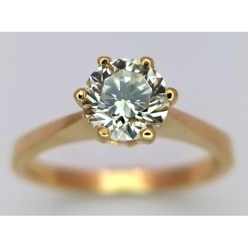 471 - An 18K Yellow Gold Diamond Solitaire Ring. A 0.75ct brilliant round cut diamond - SI1 clarity. Tinte... 