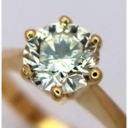 471 - An 18K Yellow Gold Diamond Solitaire Ring. A 0.75ct brilliant round cut diamond - SI1 clarity. Tinte... 