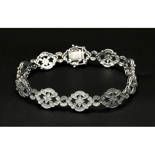 485 - An Art Deco Style 14K White Gold and Diamond Bracelet. 18cm. 10.9g. Five small stones missing so A/F... 