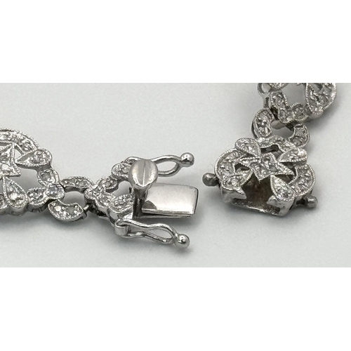 485 - An Art Deco Style 14K White Gold and Diamond Bracelet. 18cm. 10.9g. Five small stones missing so A/F... 