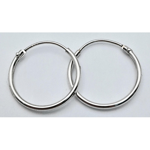 1561 - A PAIR OF 9K WHITE GOLD MINI HOOP SLEEPER EARRINGS 0.35G TOTAL WEIGHT. APPROX.  1.4CM IN DIAMETER. R... 