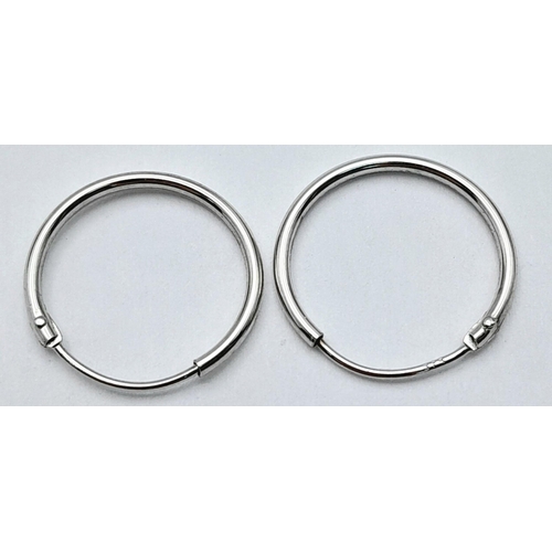 1561 - A PAIR OF 9K WHITE GOLD MINI HOOP SLEEPER EARRINGS 0.35G TOTAL WEIGHT. APPROX.  1.4CM IN DIAMETER. R... 