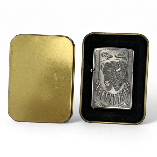 1142 - A rare vintage US Zippo Wild West Buffalo Head Lighter, comes with the original gold-tone metal tin.... 