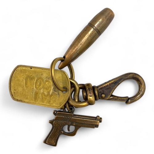 1338 - A Vietnam war era military themed Keychain, include a bullet charm, a pistol charm, a dog tag plate ... 