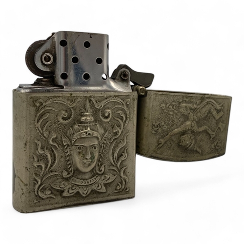 1345 - A Vintage Lighter with intricate engravings of Thai mythological figures and scenes.  Some signs of ... 