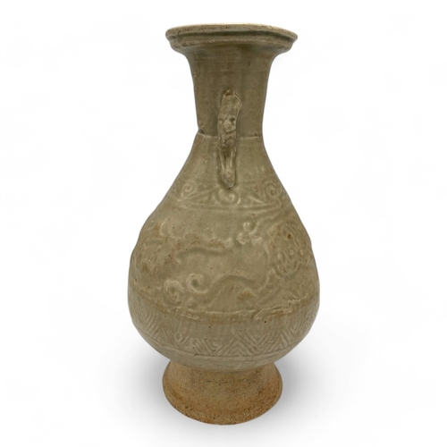 1555 - An antique Chinese Celadon Glazed Vase with Dragon Motifs. Ceramic exterior with a celadon glaze, fe... 