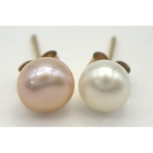 1379 - A pair of 9k yellow gold single pearl stud earrings, one white, one pink tones. 0.7g.. Ref: SH8824H