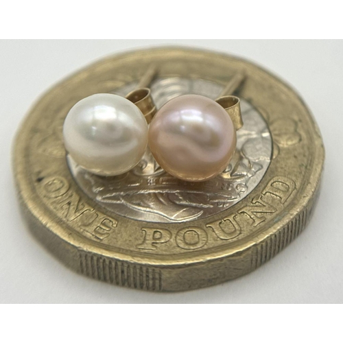 1379 - A pair of 9k yellow gold single pearl stud earrings, one white, one pink tones. 0.7g.. Ref: SH8824H