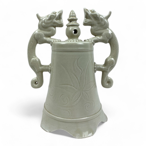 1051 - An antique Chinese Ming dynasty Celadon Green Ceramic Bell. Twin dragon-shaped handles and flared ri... 