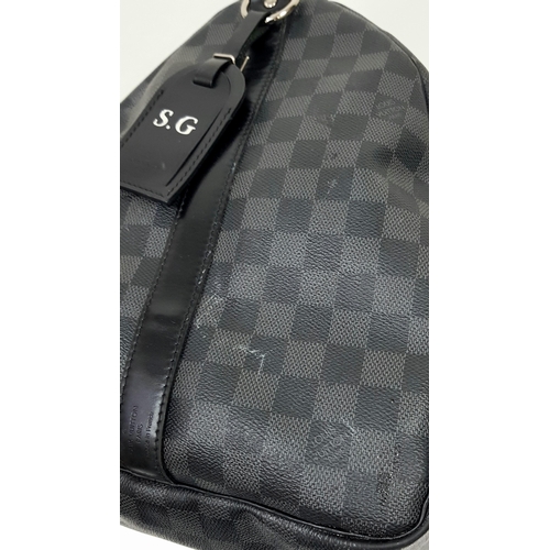 278 - A Louis Vuitton Damier Graphite Keepall 55 Travel Bag. Coated canvas exterior with leather trim, two... 