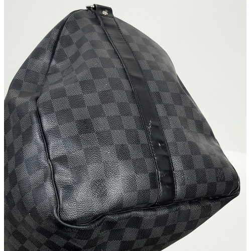 278 - A Louis Vuitton Damier Graphite Keepall 55 Travel Bag. Coated canvas exterior with leather trim, two... 