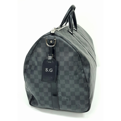 278 - A Louis Vuitton Damier Graphite Keepall 55 Travel Bag. Coated canvas exterior with leather trim, two... 