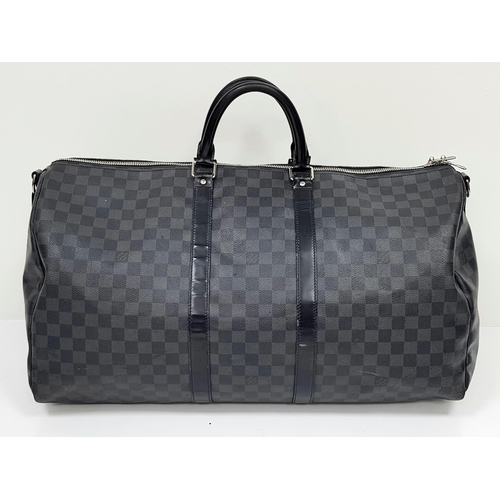 278 - A Louis Vuitton Damier Graphite Keepall 55 Travel Bag. Coated canvas exterior with leather trim, two... 