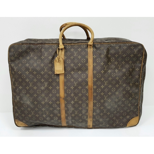 497 - A Louis Vuitton Sirius 70 Travel Bag. Monogram coated canvas exterior with leather trim, two rolled ... 